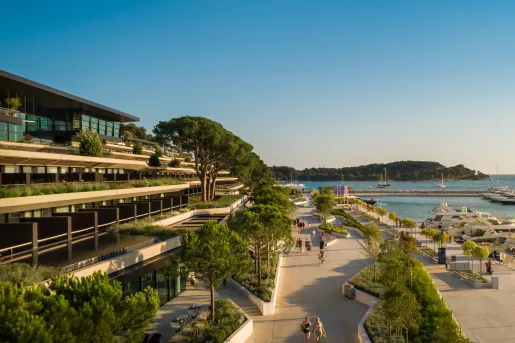 Hotel overlooking a boardwalk and water 