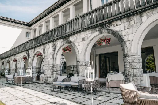 Terrace with lounge chairs and tables under an awning