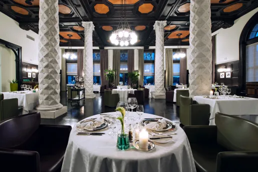 Dining room tables set with glassware in hotel restaurant