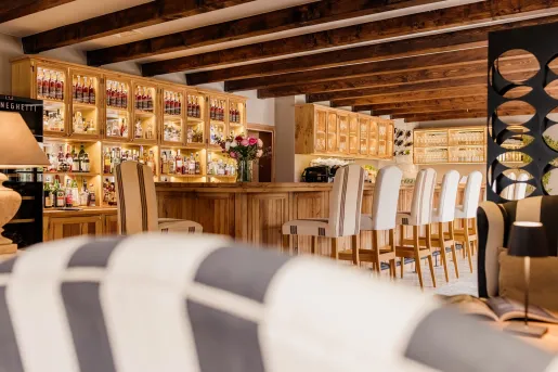 stocked bar with bar chairs