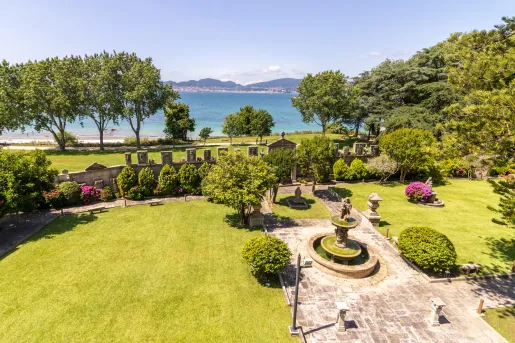 Open grass courtyard with a fountain in the center