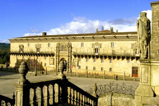 Rustic, Spanish-style building with a statue in a large courtyard