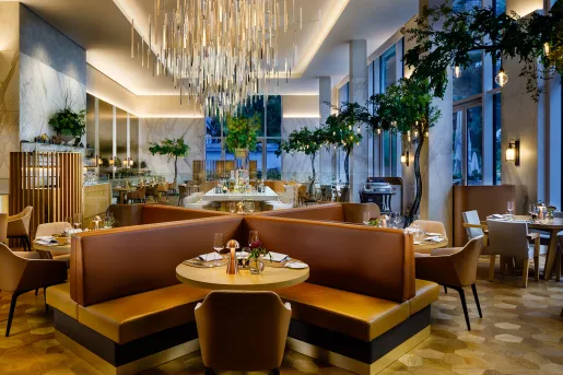 hotel lobby with chairs and large chandelier
