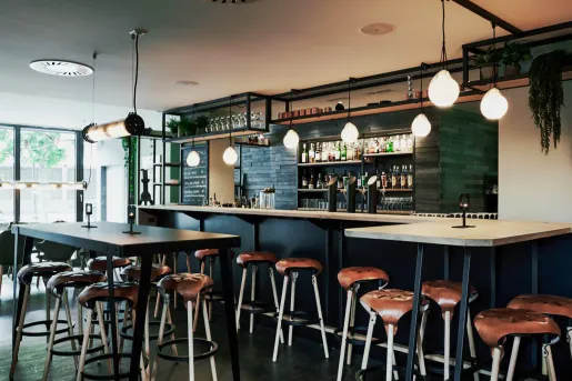 Indoor bar and lounge with leather barstools and light fixtures