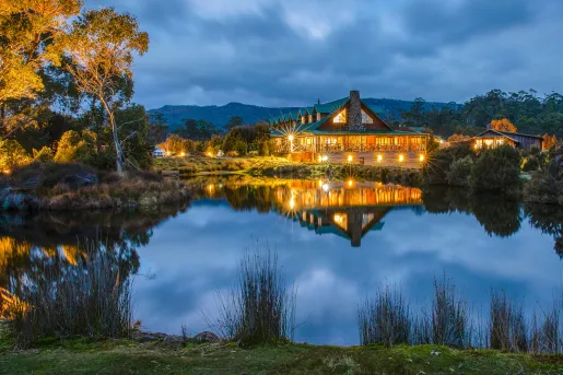 hotel lit up at night across a lake
