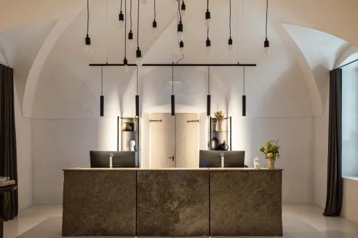 Front desk concierge area with two computers and dangling lights