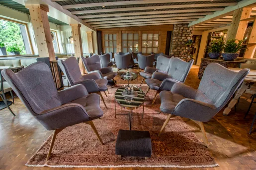 Indoor seating area and lounge with gray, cushioned chairs