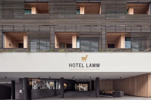 Outdoor view of a hotel sign with rooms and outdoor balconies