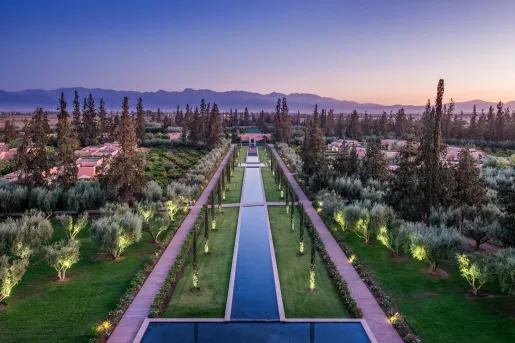 Sky view of long fountain with concrete pathways on either side