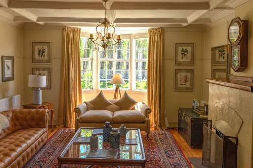 Lobby with cushioned couches in front of a fireplace