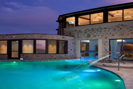 hotel pool lit up at night