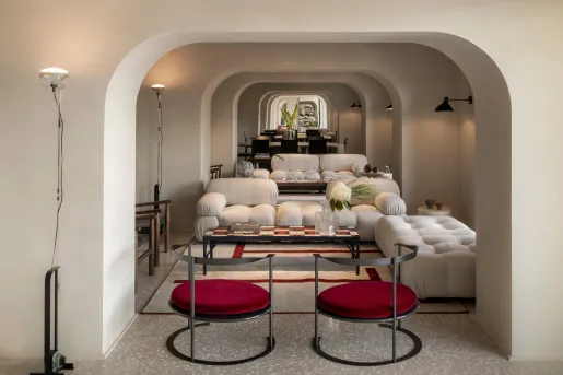 Lounge with arched hallways with white and red cushioned seating