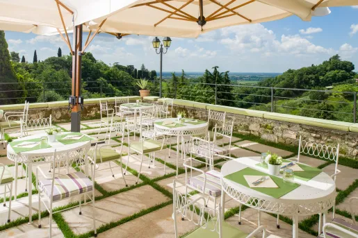 large terrace with bistro tables and umbrellas covering them