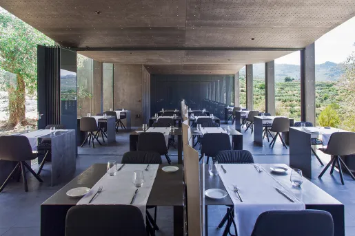 tables in a hotel restaurant with glass walls