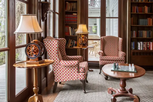 hotel library room with books and chairs