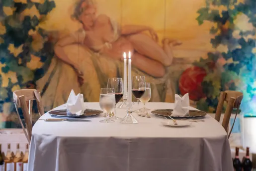 Dining table with two candles and two glasses of wine