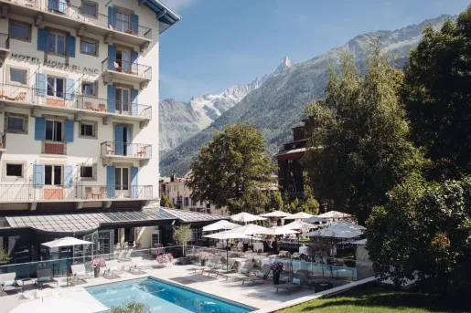hotel and pool next to mountain