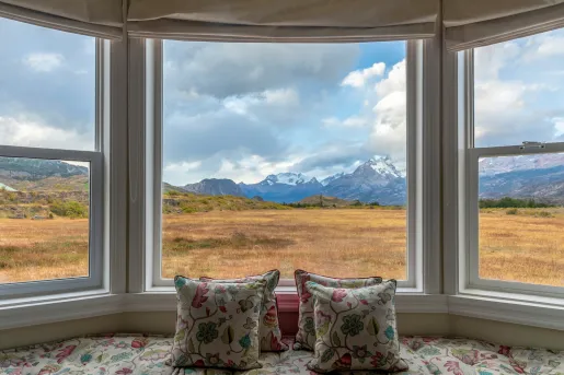 large bay windows looking onto mountains