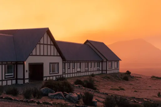 orange sunset behind hotel building