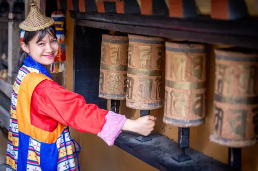 Woman in a traditional dress, walking through a temple