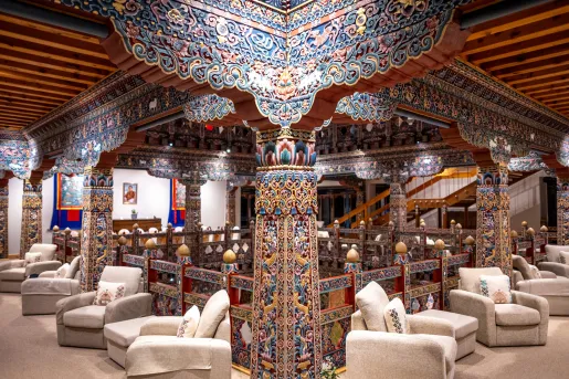Second floor indoor lobby with cushioned chairs and traditional-style pillars
