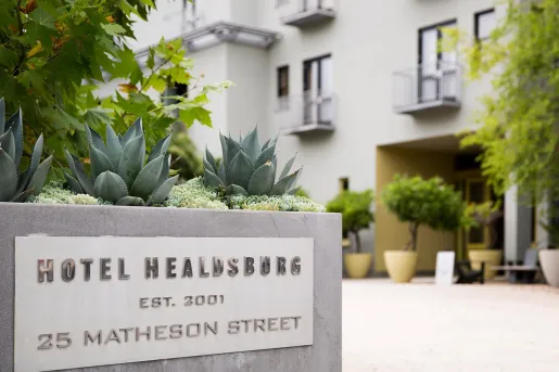 Stone hotel sign with cactus on top