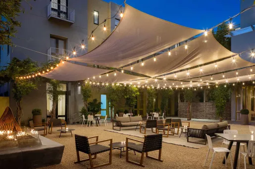 Outdoor patio area with a fireplace on the left and skylights