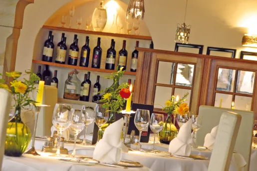 dining room with wine bottles on back wall