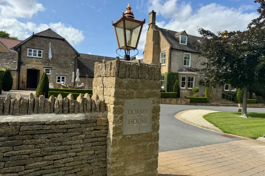 stone gates to a large stone home