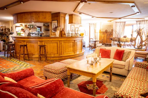 round wooden bar surrounded by large couches in wooden living room