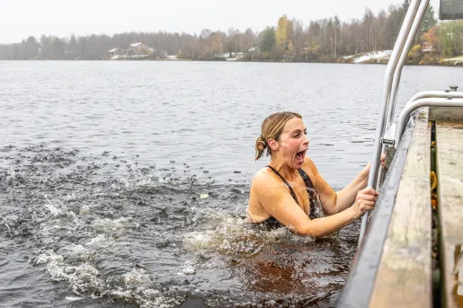 Women jumping into a cold lake