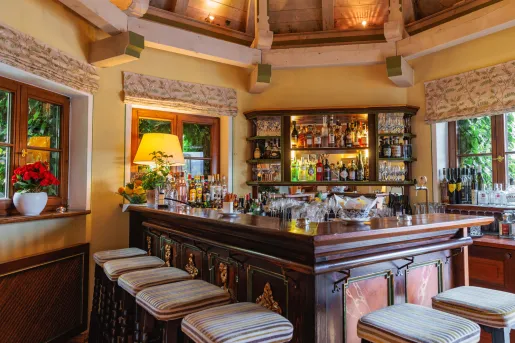 Wooden bar with stools surrounding the bar area