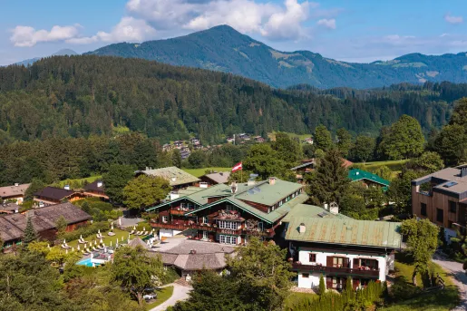 Exterior, sky view of wooden hotel building complex in a valley of tall trees