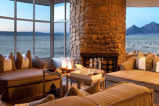 lodge with fireplace and view of water