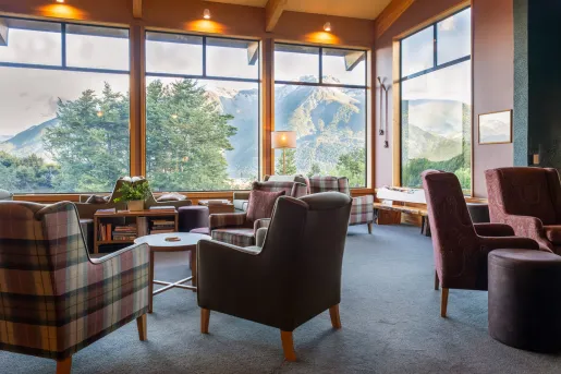 living room with arm chairs and large windows