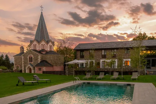 Outdoor pool with a castle-like building in the background