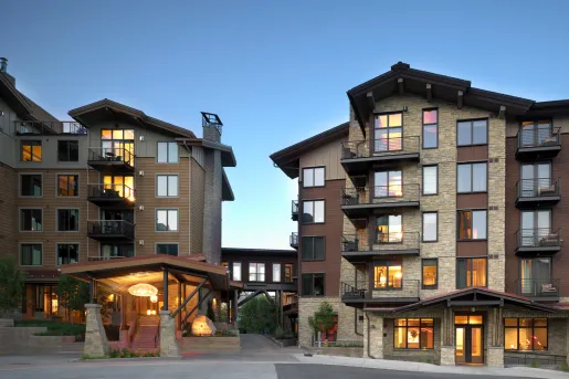 Exterior view of stone hotel building with metal balconies