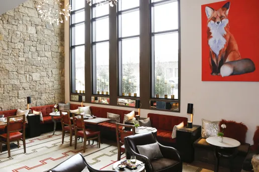 dining room with red couches and large windows