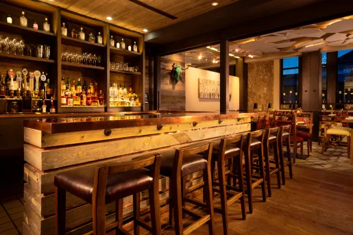 wooden bar with barstools