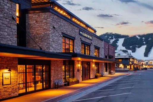 Hotel building made of stone and surrounded by bright orange lights
