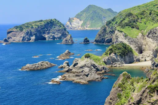 Ocean with large cliffs and boulders to the right