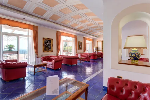 Lobby with blue tile flooring and red leather couches