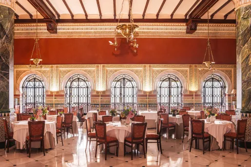 Indoor dining hall with tables and wooden chairs