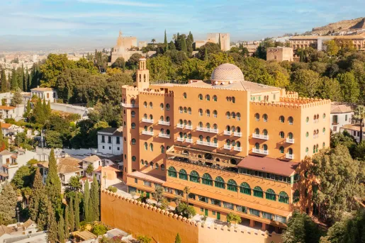 Exterior view of yellow, multi-story hotel building