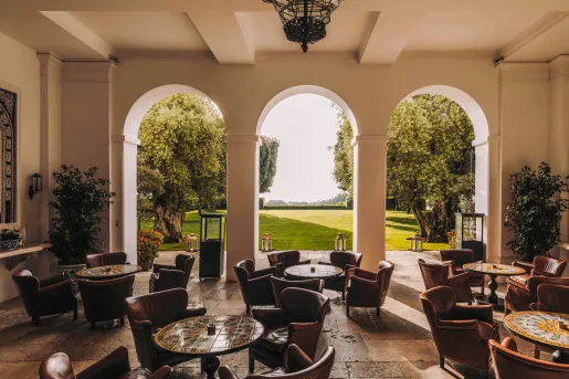 Seating area with large arches leading to an outdoor garden