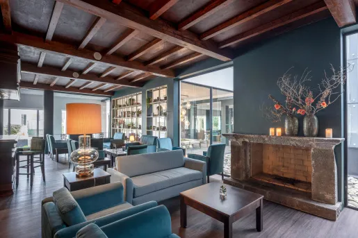 Lobby with cushioned chairs and windows in the background