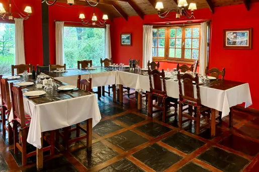 Dining hall with tables shaped in a half circle, with bright red walls