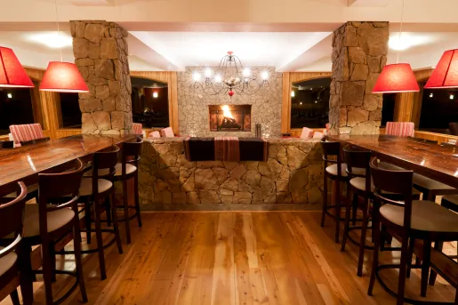 Restaurant with long, wooden tables and tall stools