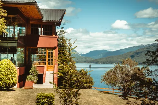 Exterior view of a red building next to a lake