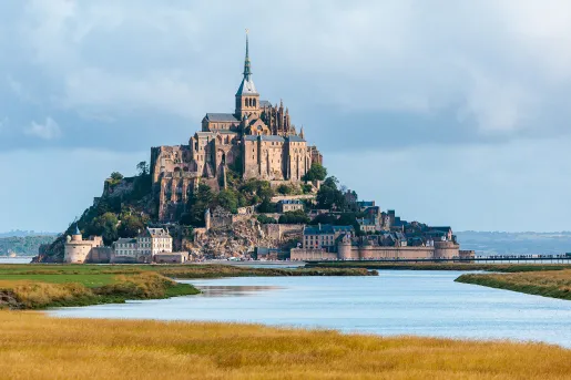 Castle-like cathedral building on an island, surrounded by ponds of water